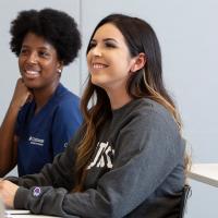 Two female nursing students in class.